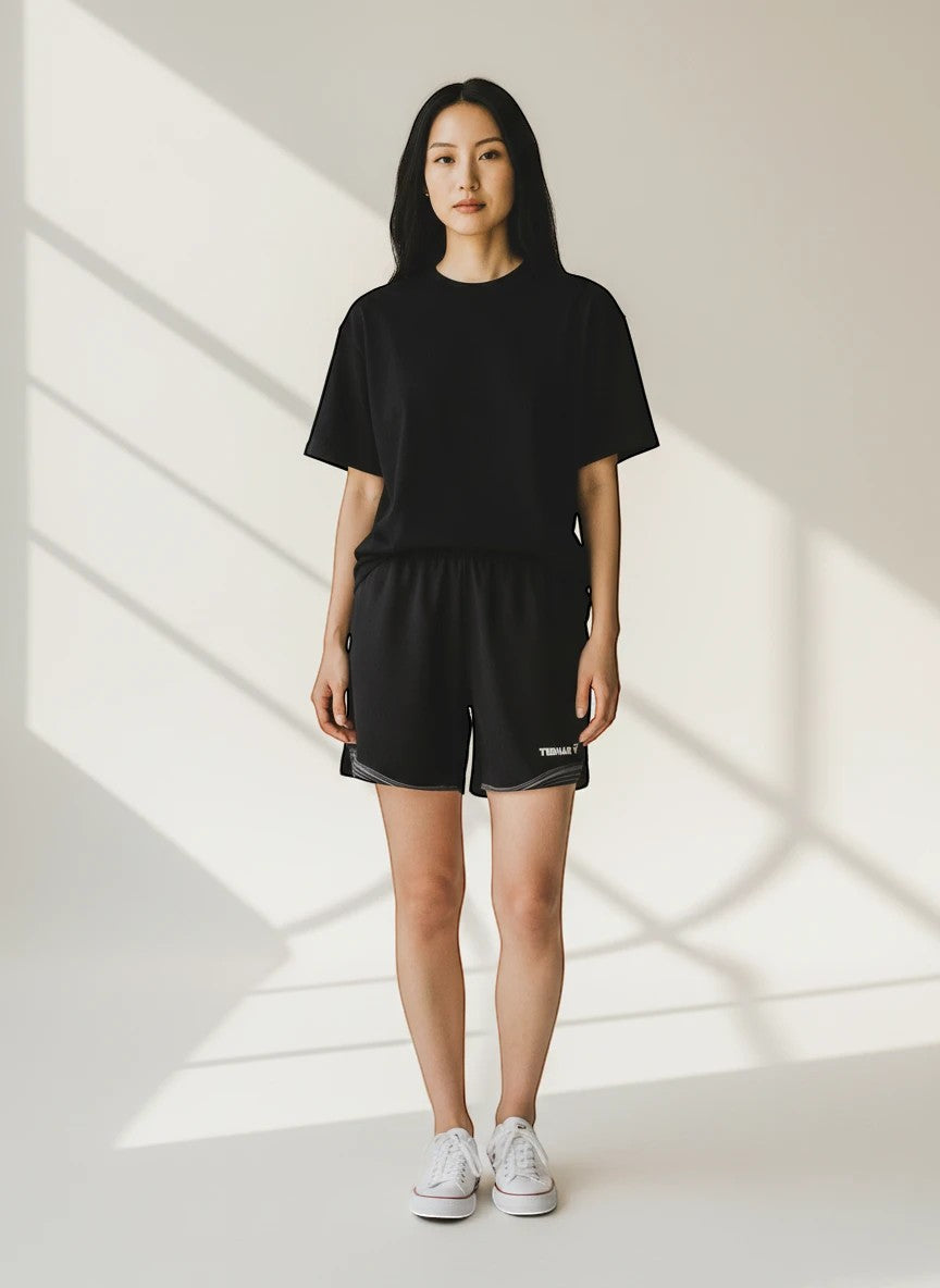 TTM-Store Tibhar L2 River black polyester-elastane table tennis shorts with grey accents and side slits.