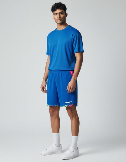 TTM-Store Tibhar L2 Underbrush blue polyester shorts with pink accents and a colorful geometric print hem. Designed for active wear.