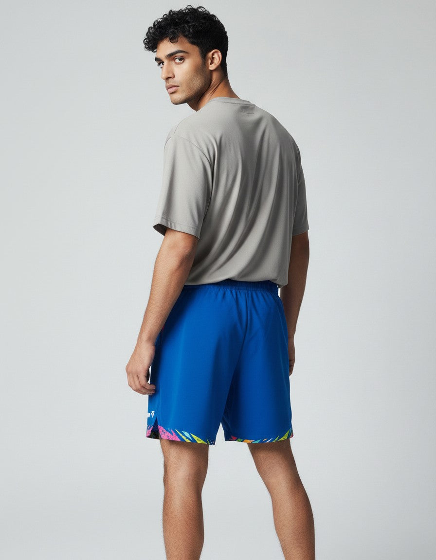 TTM-Store Tibhar L2 Underbrush royal blue polyester shorts with pink accents and abstract print hem, elastic waistband, and side slits.